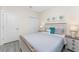 Bedroom with gray bedding, nightstands, and calming decor at 7186 Rosemont Dr, Englewood, FL 34224