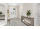 Bright and airy entryway with wood-look floors and stylish console table at 7186 Rosemont Dr, Englewood, FL 34224