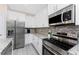 Modern kitchen with stainless steel appliances and granite countertops at 7186 Rosemont Dr, Englewood, FL 34224