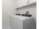 Laundry room with Whirlpool washer and dryer, and white cabinets at 7186 Rosemont Dr, Englewood, FL 34224