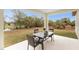 Relaxing patio with table and chairs, overlooking a pond and lush landscape at 7186 Rosemont Dr, Englewood, FL 34224