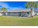 Home exterior showcasing a large backyard and screened patio at 7329 Mamouth St, Englewood, FL 34224