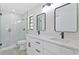 Modern bathroom with double vanity, quartz countertop, and glass shower at 7329 Mamouth St, Englewood, FL 34224