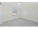 Simple bedroom with gray tile flooring and a window at 7329 Mamouth St, Englewood, FL 34224