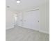 Bright bedroom with double door closet and gray floors at 7329 Mamouth St, Englewood, FL 34224