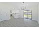 Bright dining room features modern chandelier and view to backyard at 7329 Mamouth St, Englewood, FL 34224