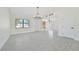 Spacious dining area with tile floors and a modern chandelier at 7329 Mamouth St, Englewood, FL 34224