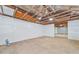 Unfinished garage interior with exposed ceiling beams and cement floor at 7329 Mamouth St, Englewood, FL 34224