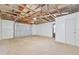 Unfinished garage interior with exposed ceiling beams and garage door at 7329 Mamouth St, Englewood, FL 34224