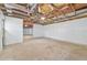 Unfinished garage interior with exposed ceiling beams and cement floor at 7329 Mamouth St, Englewood, FL 34224