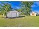 Detached garage and shed in a grassy backyard at 7329 Mamouth St, Englewood, FL 34224