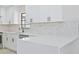 Kitchen boasts quartz countertop and marble backsplash at 7329 Mamouth St, Englewood, FL 34224