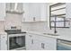 Stainless steel range, oven, and vent hood in modern kitchen at 7329 Mamouth St, Englewood, FL 34224