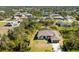 Aerial view of single-story house with spacious lot and surrounding homes at 7442 Clearwater St, Englewood, FL 34224