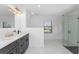 Modern bathroom with double vanity, large shower, and marble floors at 7442 Clearwater St, Englewood, FL 34224