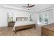 Bright bedroom with king-size bed, wood floors, and access to a private patio at 7442 Clearwater St, Englewood, FL 34224