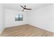 Bright bedroom featuring light wood-look flooring and ceiling fan at 7442 Clearwater St, Englewood, FL 34224