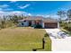 Single-story home with a brown door and attached garage at 7442 Clearwater St, Englewood, FL 34224