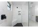 Large walk-in shower with marble tile and built-in shelving at 7442 Clearwater St, Englewood, FL 34224