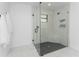 Walk-in shower with marble walls and pebble stone floor at 7442 Clearwater St, Englewood, FL 34224