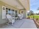 Inviting front porch with rocking chairs, perfect for relaxing at 7586 Sea Mist Dr, Port Charlotte, FL 33981