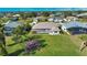 Aerial view of a home with a large backyard and screened lanai at 8 Sportsman Rd, Rotonda West, FL 33947