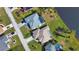 Aerial view of two homes, one with a pool, near a lake at 8 Sportsman Rd, Rotonda West, FL 33947