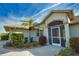 Front entrance with a screened porch and lush landscaping at 8 Sportsman Rd, Rotonda West, FL 33947