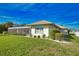 Side view of house with lush landscaping at 8 Sportsman Rd, Rotonda West, FL 33947