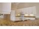 Modern kitchen with granite countertops and white cabinets at 8 Sportsman Rd, Rotonda West, FL 33947