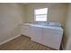 Laundry room with utility sink and plenty of storage at 8 Sportsman Rd, Rotonda West, FL 33947