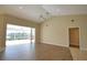 Spacious living room featuring high ceilings, sliding glass doors, and wood-look floors at 8 Sportsman Rd, Rotonda West, FL 33947