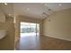 Bright living room with high ceilings, sliding doors to patio, and wood-look flooring at 8 Sportsman Rd, Rotonda West, FL 33947