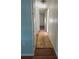 Hallway with light wood flooring and access to other rooms at 8194 Robert St, Englewood, FL 34224