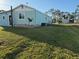 Side view of the mobile home with satellite dish and grass at 8194 Robert St, Englewood, FL 34224