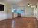 Living room with laminate flooring and kitchen view at 8194 Robert St, Englewood, FL 34224