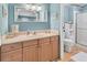 Clean bathroom with light wood cabinets and a shower at 844 Seabrooke Ct, Englewood, FL 34223