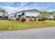 Gray mobile home with awnings and manicured lawn at 844 Seabrooke Ct, Englewood, FL 34223