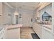 Clean kitchen featuring white appliances and pink cabinets at 844 Seabrooke Ct, Englewood, FL 34223