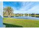 Pond view from backyard with lush grass at 8768 Conch Ave, Placida, FL 33946