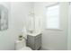 Small bathroom with toilet, sink, and vanity at 8768 Conch Ave, Placida, FL 33946