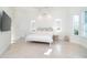 Main bedroom with large windows, white bedding and ensuite bathroom at 8768 Conch Ave, Placida, FL 33946