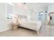 Bright bedroom with large windows, white bedding, and ensuite bath at 8768 Conch Ave, Placida, FL 33946