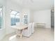 Modern dining room with white table and bench at 8768 Conch Ave, Placida, FL 33946