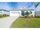 A light blue one-story house with a white garage and blue door at 8768 Conch Ave, Placida, FL 33946