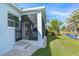 Back exterior view showing access to a screened patio and a pond at 8768 Conch Ave, Placida, FL 33946