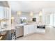 Bright white kitchen with stainless steel appliances and breakfast bar at 8768 Conch Ave, Placida, FL 33946