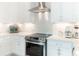 White kitchen with stainless steel appliances at 8768 Conch Ave, Placida, FL 33946