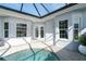 Private pool with a glass roof enclosure and access to the house at 8768 Conch Ave, Placida, FL 33946