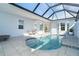 An inviting screened-in pool and patio with lounge chairs at 8768 Conch Ave, Placida, FL 33946